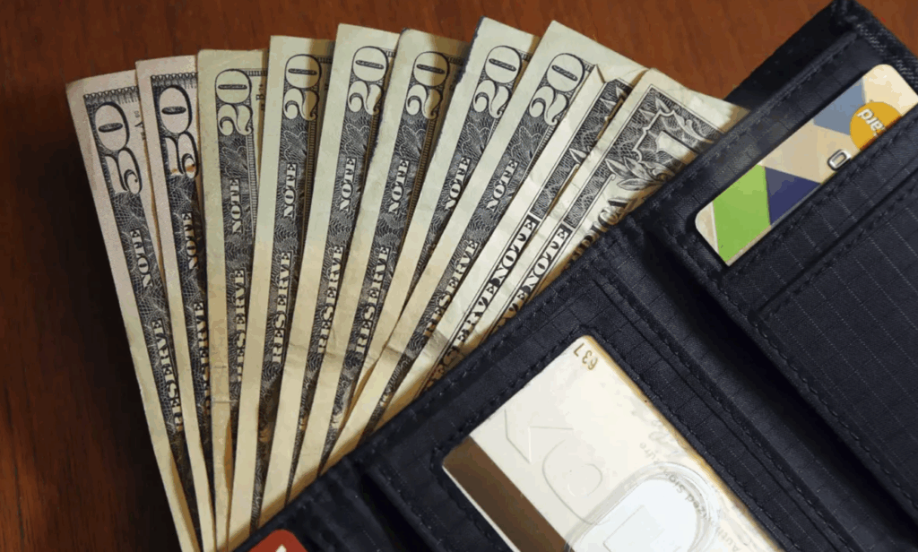 two fifty dollar bills and six twenty dolla bills in a wallet