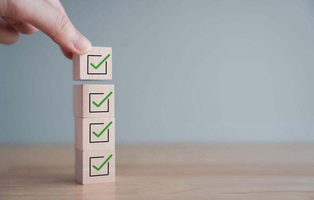 someone balancing four blocks that each have a checkmark